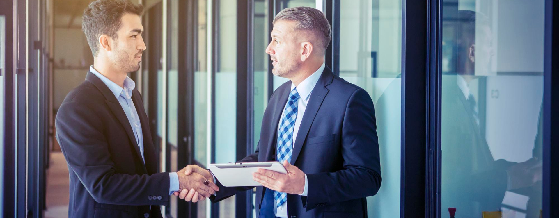 Businesspeople shaking hands, symbolizing a successful outsourcing partnership that drives growth