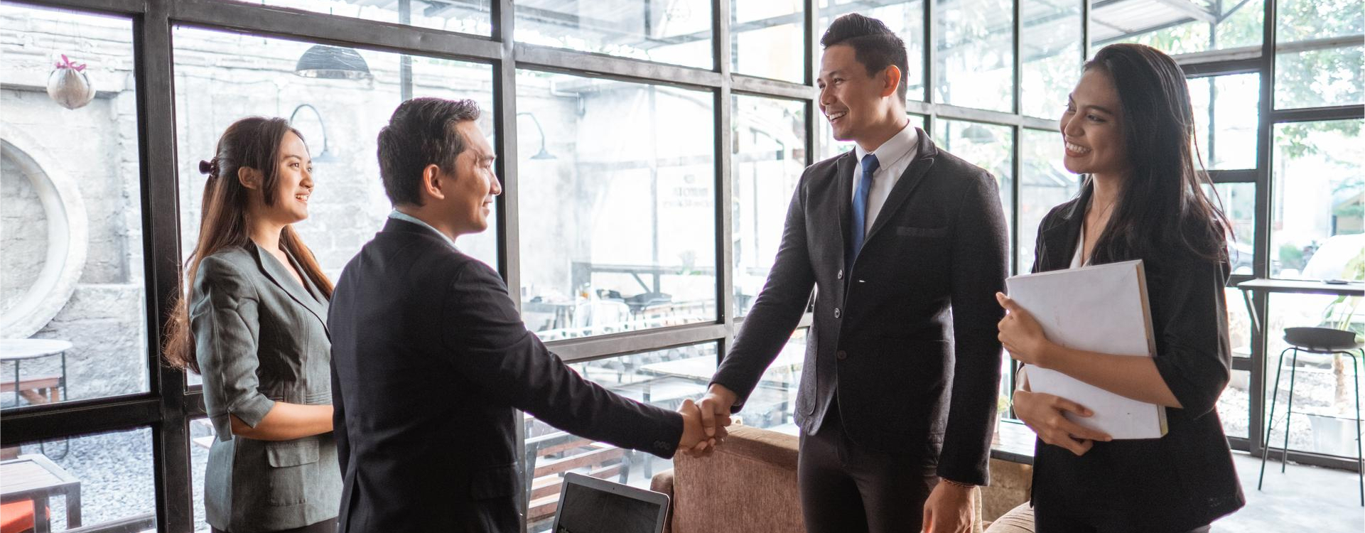 Business professionals shaking hands, representing outsourcing partnerships and commonly outsourced jobs