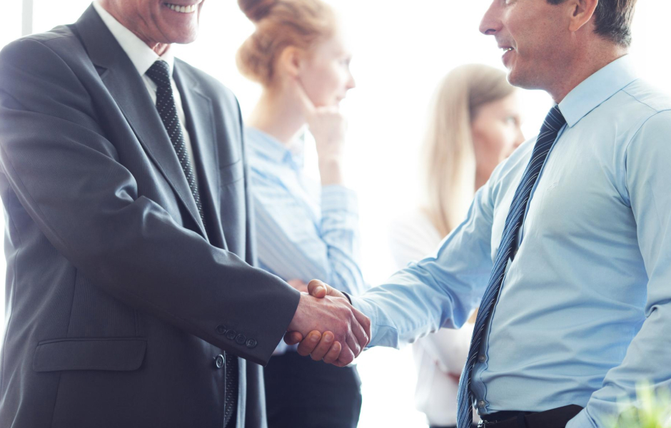 A handshake between business partners symbolizing a successful outsourcing relationship and partnership