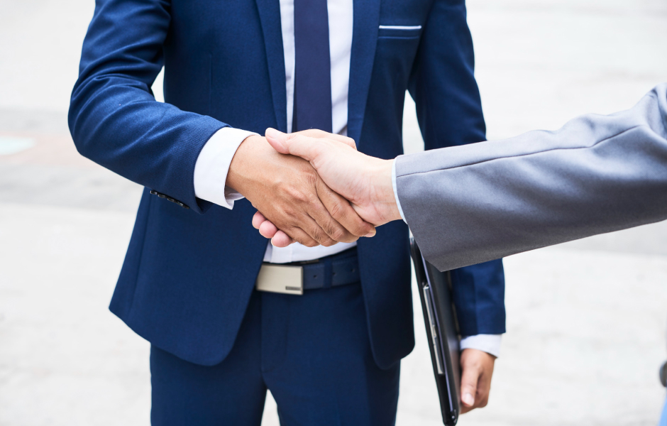 Handshake between business leaders symbolizing successful offshoring partnership, collaboration and trust